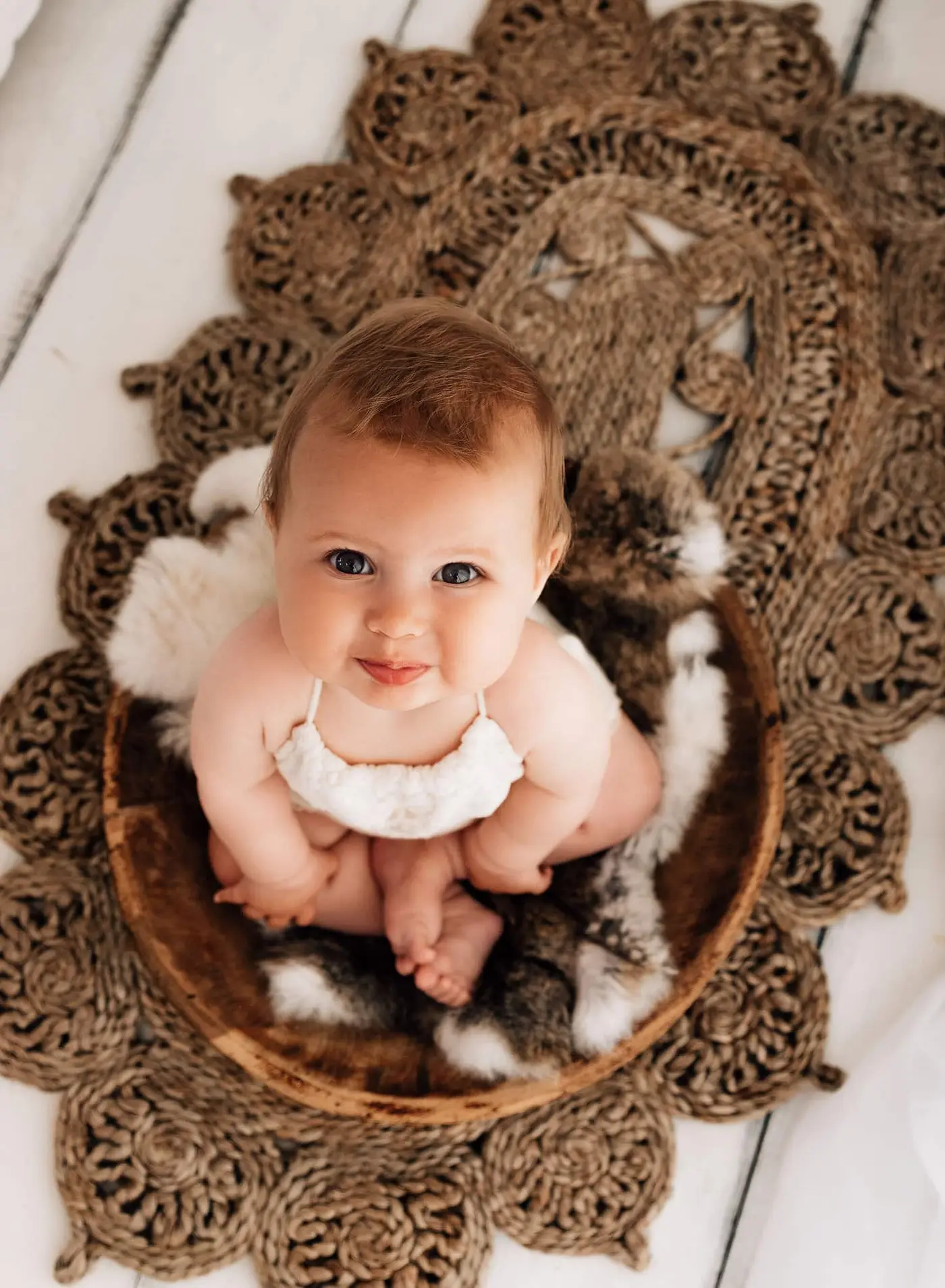 baby sat up ooking at the camera at a bradford baby photographer photoshoot