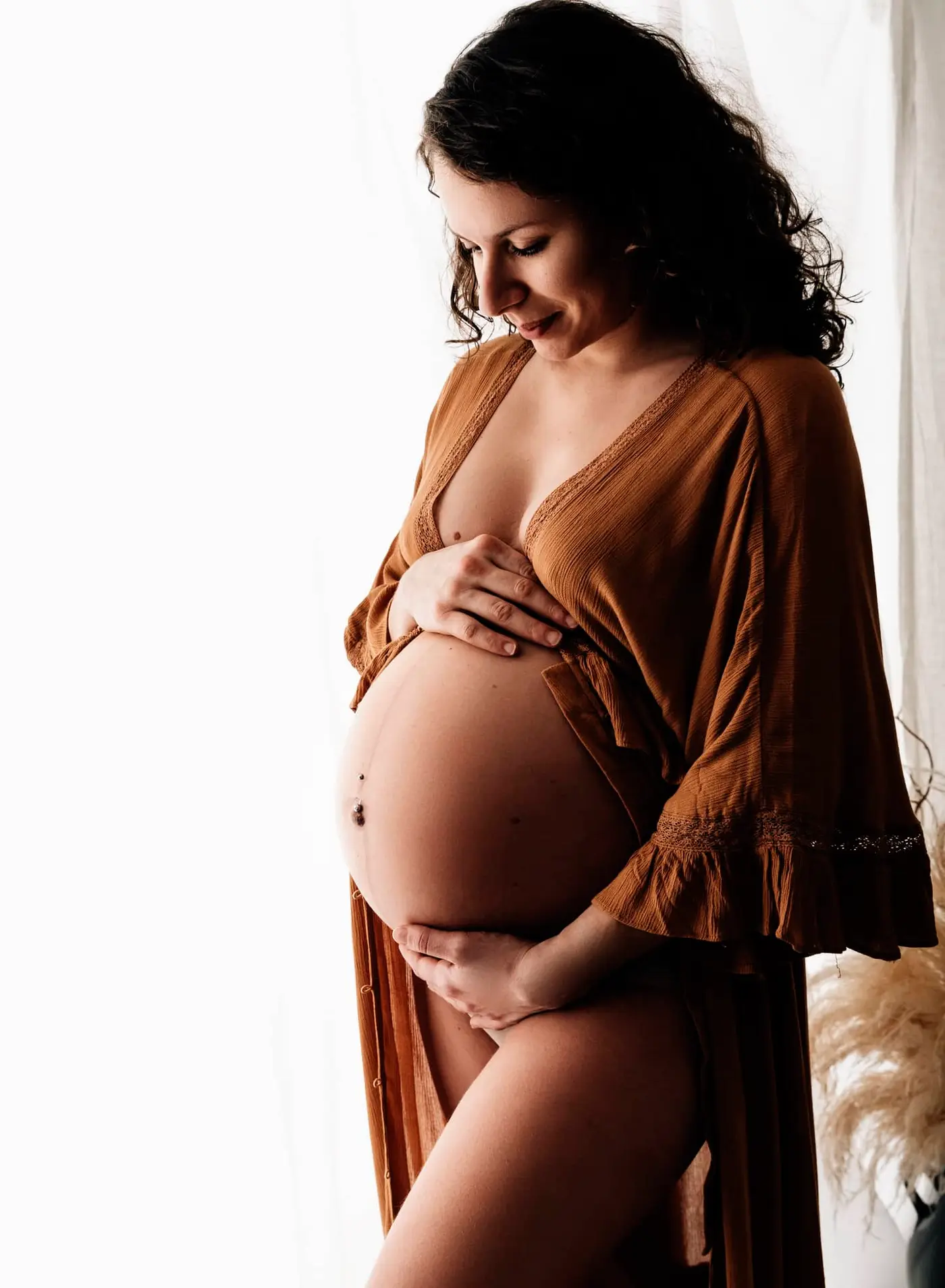 pregnant lady holding bump during maternity photoshoot during cleckheaton
