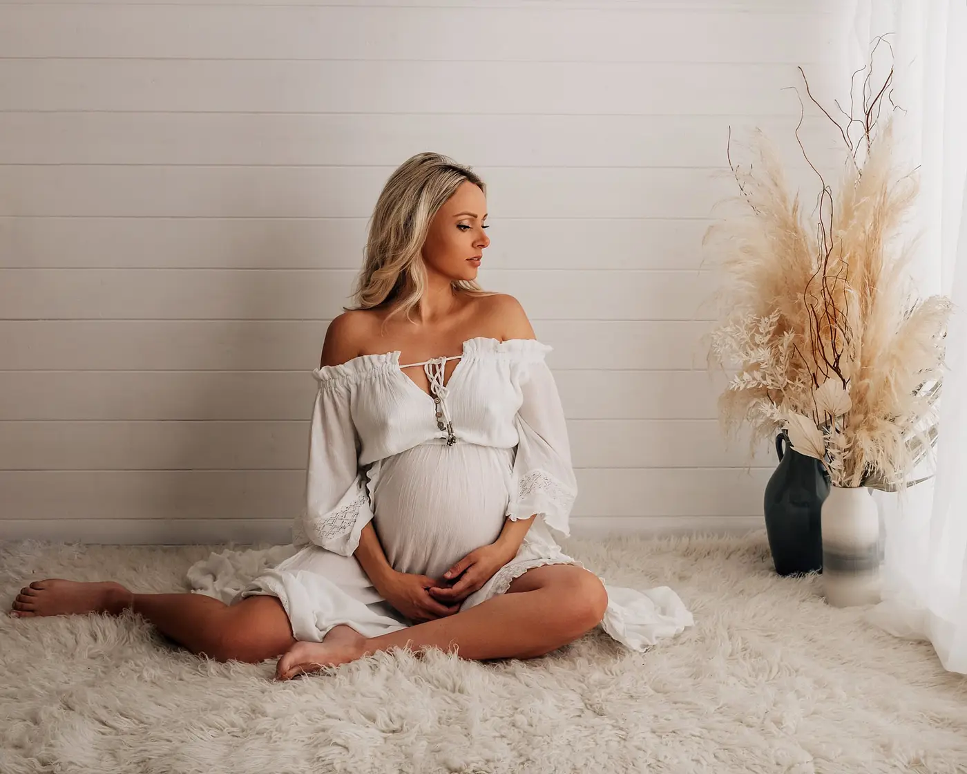 pregnant lady sat holding bump during a cleckheaton maternity photography photoshoot