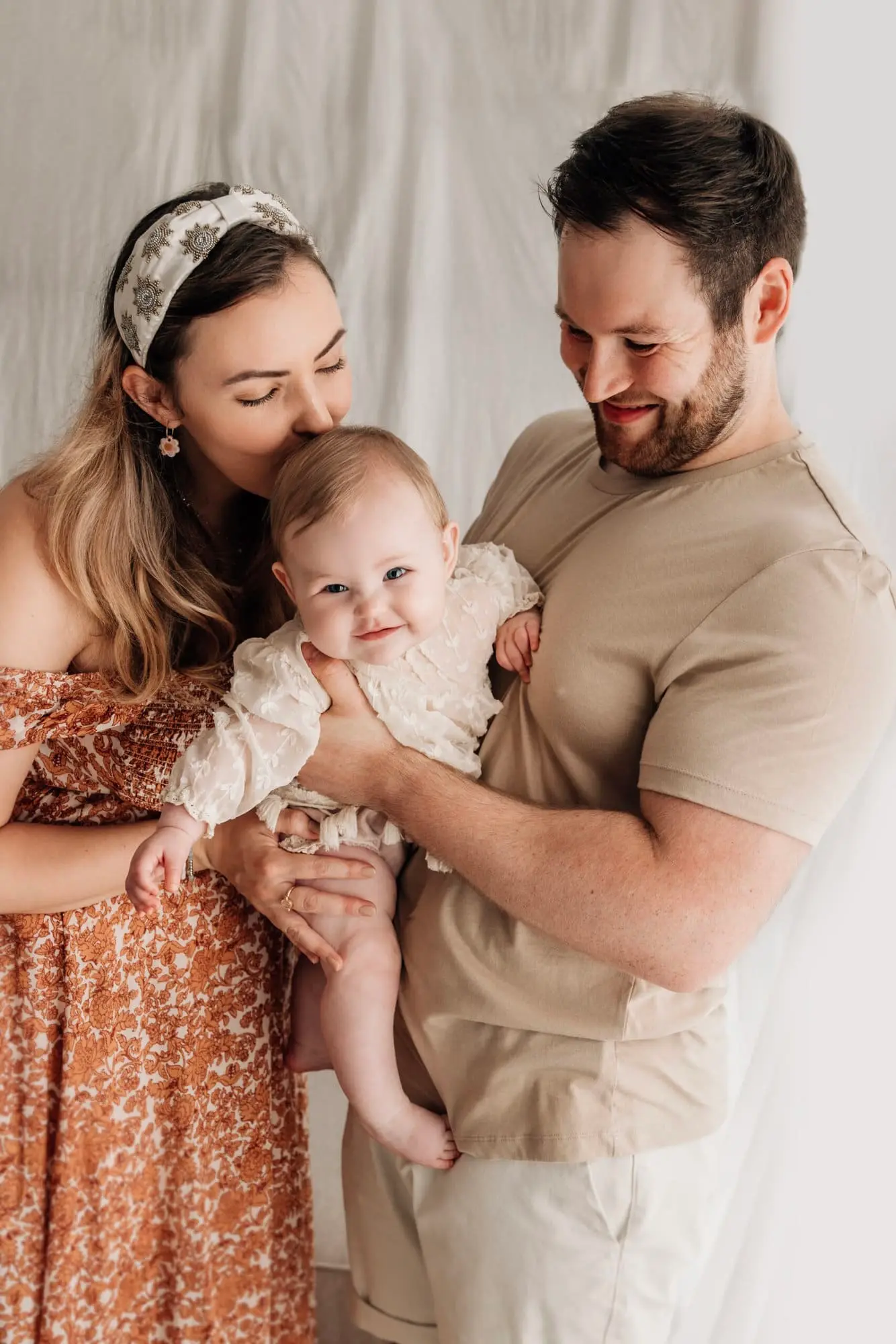 family smiling and laughing at a studio photoshoot in leeds