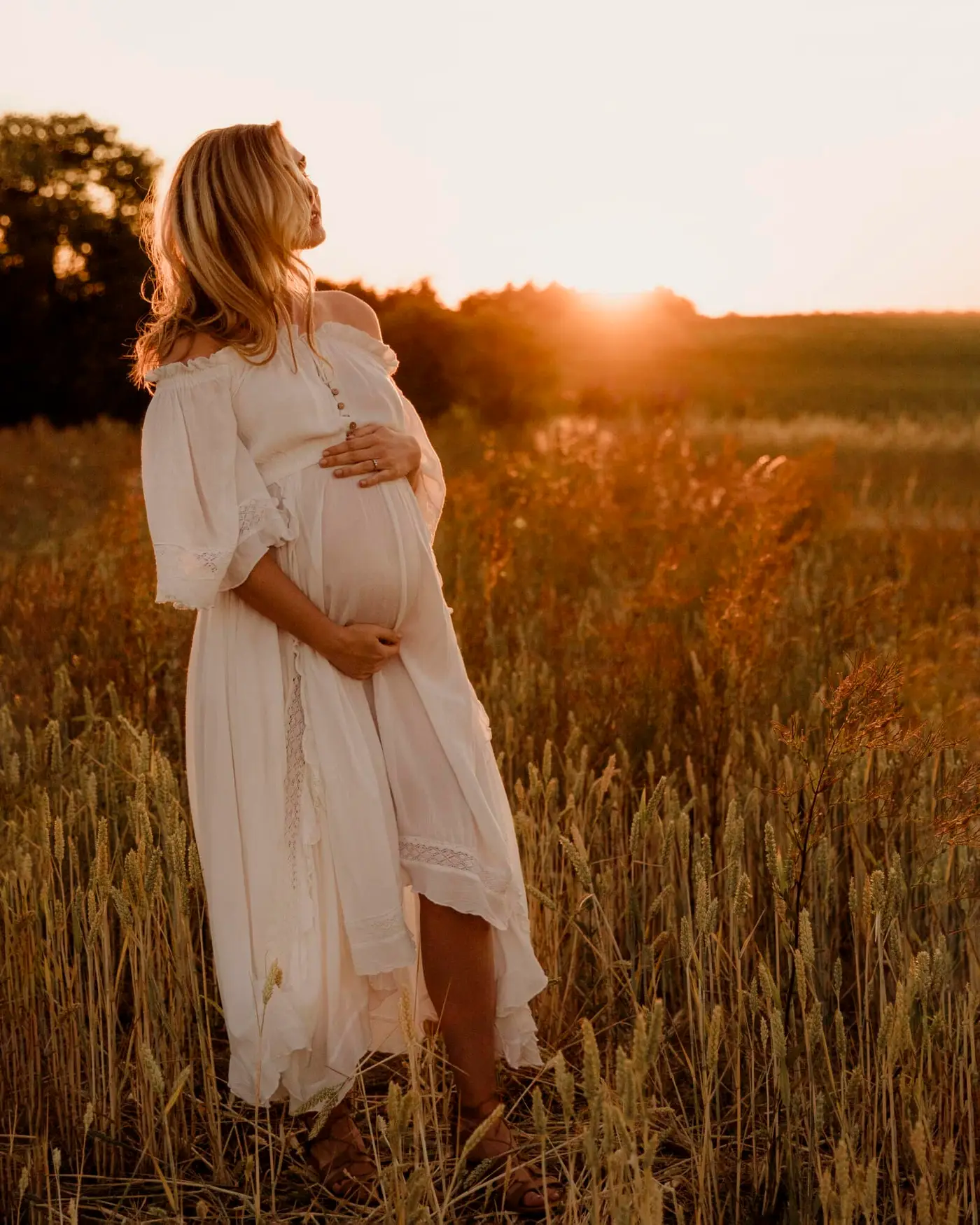 pregnant lady looking into the sunset during her maternity photoshoot in bradford