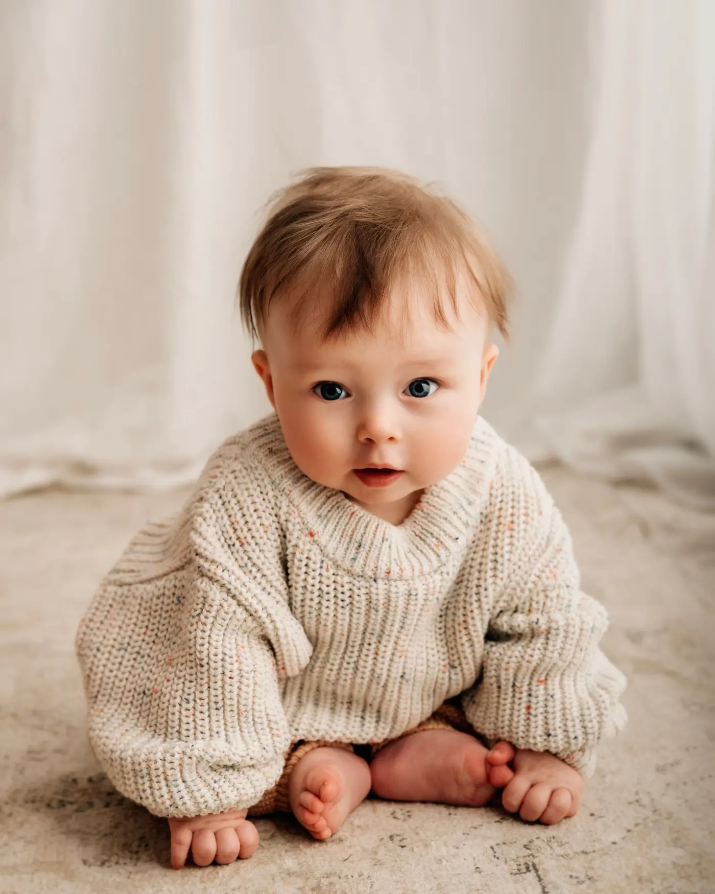 baby sitting up during a photography photoshoot in bradford